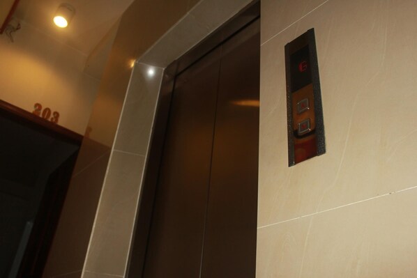 An elevator with a control panel and a number "203" on the wall. - Vien Dong Hotel (Ho Chi Minh City)