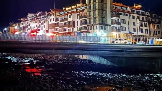 A large, multi-story building with a prominent tower and illuminated signage. - Bansko Royal Towers - Apartments (Bansko)