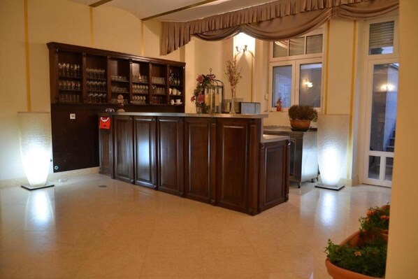 A spacious room with a central wooden bar, a large cabinet with glassware, and a window with curtains. - Jardin Hotel Belgrade (Belgrade)