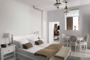 A hotel room with a large bed, bedside tables, a desk, a chair, a small table, and a mirror. - Jardin Hotel Belgrade (Belgrade)