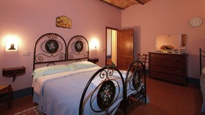 A bedroom with a bed, dresser, and a mirror. - Peaceful Pienza Garden Escape (Pienza)