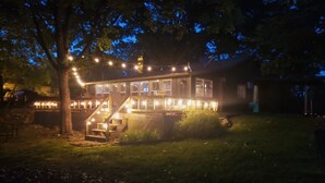 A house with a deck, stairs, and string lights. - Raper’s Hollow Waterfront Cabin (Eucha)