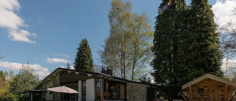 A stone building with a pool and outdoor seating.