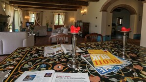 A room with a dining table set for two, featuring a magazine and a menu. The room has a wooden ceiling and a tiled floor. - Scenic Stay in Poppi With Pool (Poppi)