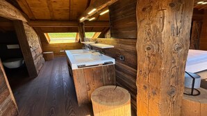 A wooden cabin bathroom with a large window, a sink, and a toilet. - Chalet in Ovifat Near Ski Slopes (Waimes)