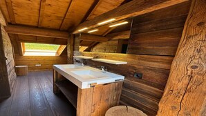 A wooden cabin bathroom with a large sink, wooden walls, and a skylight. - Chalet in Ovifat Near Ski Slopes (Waimes)