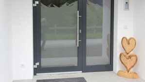 A modern sliding glass door with a view of a mountain landscape. - Luxury Holiday Flat With Balcony in Fugenberg (Fuegenberg)
