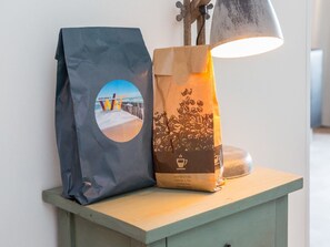A bag with a beach scene and text, and a lamp on a wooden table. - Apartment in Koudekerke Near Seabeach (Koudekerke)