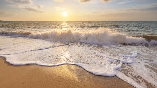 A beach with waves approaching the shore and a sunset in the background. - Nice Apartment With Garden Near the North Sea (Julianadorp)