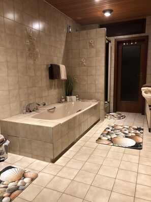 Bathtub, hair dryer, towels, soap
