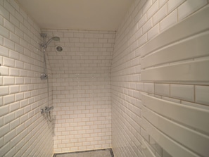 A small, enclosed shower area with white tiled walls and a showerhead. - A Superb Cottage in the Middle of a Natural Park (Hotton)