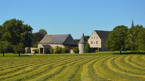 A large estate with a main building, a smaller annex, and a church steeple. - Spacious Family Home, Sosoye (Anhée)