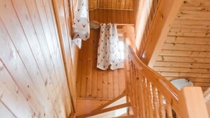 A wooden staircase with a handrail, leading to a room with wooden walls and a ceiling. - Holiday Home in Rattersberg Bavaria With Terrace (Viechtach)