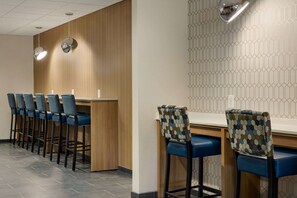 A bar area with multiple stools and a counter. - Microtel Inn & Suites by Wyndham Gambrills (Gambrills)