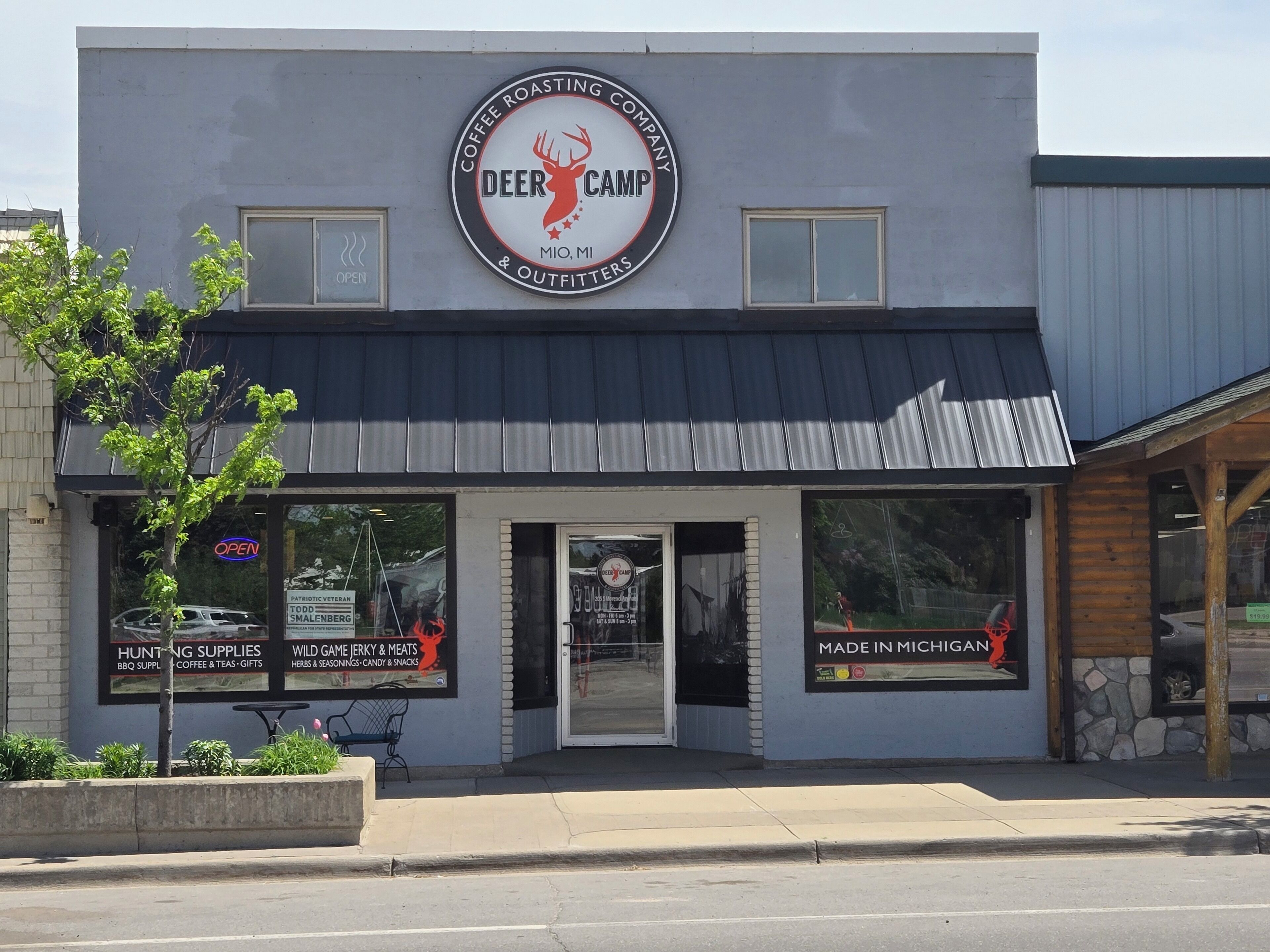 A coffee roasting company with a deer logo, hunting supplies, and a sign for Todd Smallberg.