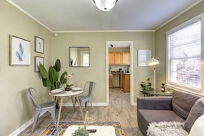 A compact living space with a dining area, a kitchenette, and a seating area with a sofa and a coffee table. - J 82 · Peaceful Retreat in Gated Midtown Community (Memphis)