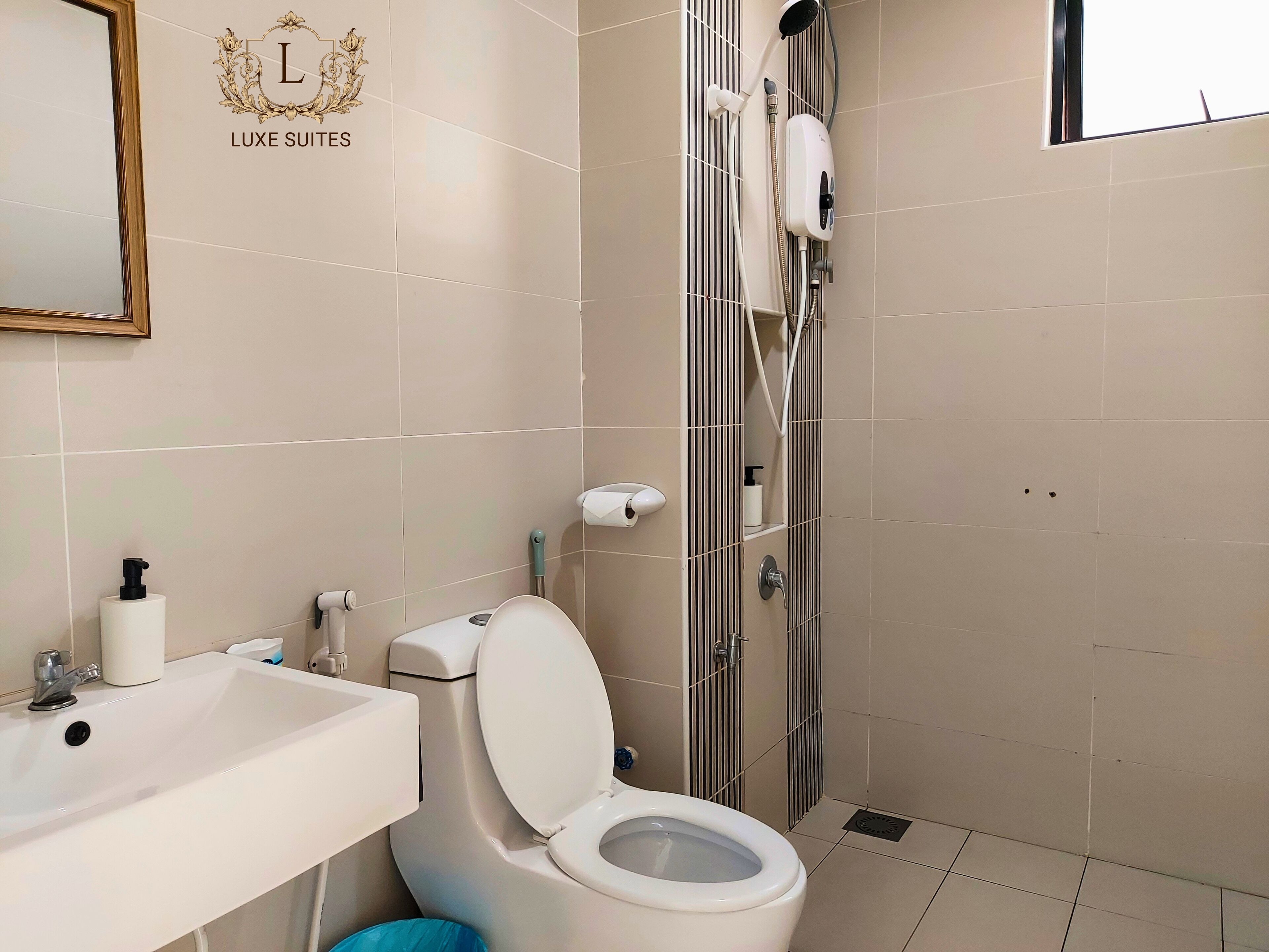 A bathroom with a toilet, sink, and shower.