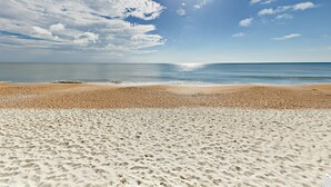 A beach with a clear sky and sunlight.