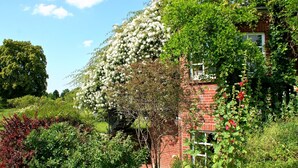 A brick house with a garden.