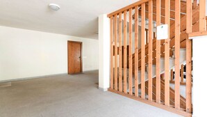 A hallway with a wooden gate leading to a staircase. - Spacious Chalet with Garden near Ski Area in Tyrol (San Giovanni di Fassa)