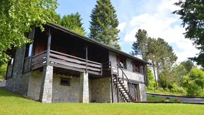 A stone building with a balcony and a staircase leading to an upper level. - Pretty Cottage Ardennes near Valley of Lesse & Semois (Gedinne)