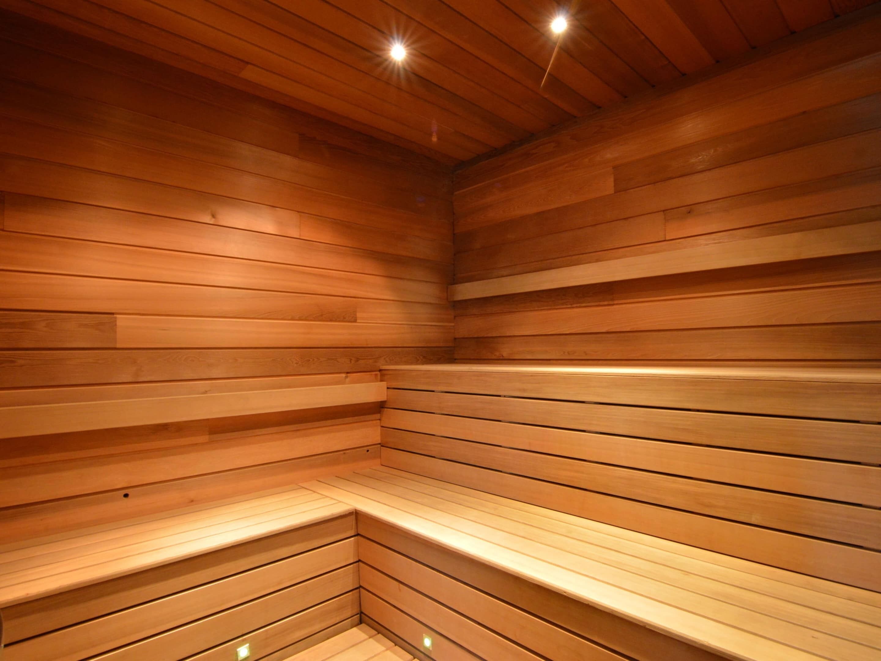 A sauna with wooden walls and benches.