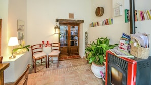 A cozy interior with a fireplace, wooden furniture, and a bookshelf. - Cottage in Montefiore Near Forest and Beach (Montefiore Conca)
