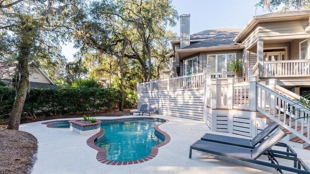 A residential property with a swimming pool, a covered deck, and a staircase leading to a second floor. - 4 Lark Street - 4th Row North Forest Beach (Hilton Head Island)