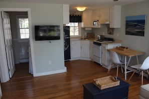 Kitchen and dining area with four chairs.