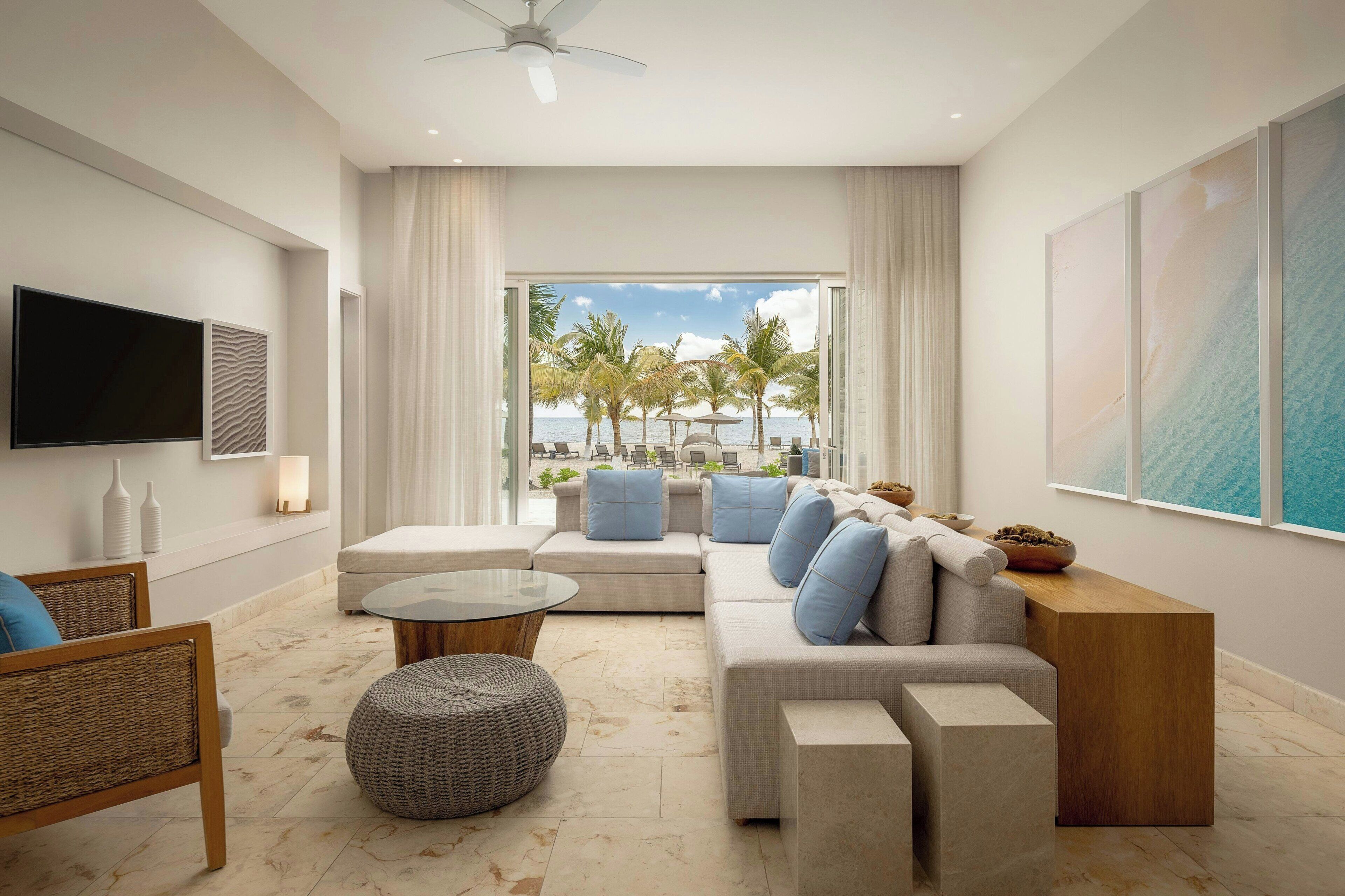A modern living room with a sofa set, a coffee table, and a television.