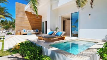 A modern outdoor pool area with lounge chairs and a wooden deck.