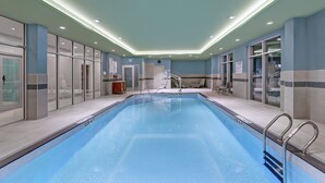 An indoor swimming pool with clear water, surrounded by glass walls and a tiled floor. - Holiday Inn Express & Suites Port Elgin by IHG (Saugeen Shores)