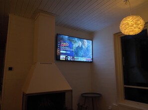 Enjoy a cozy evening by the fireplace, watching your favorite show on the wall-mounted TV.