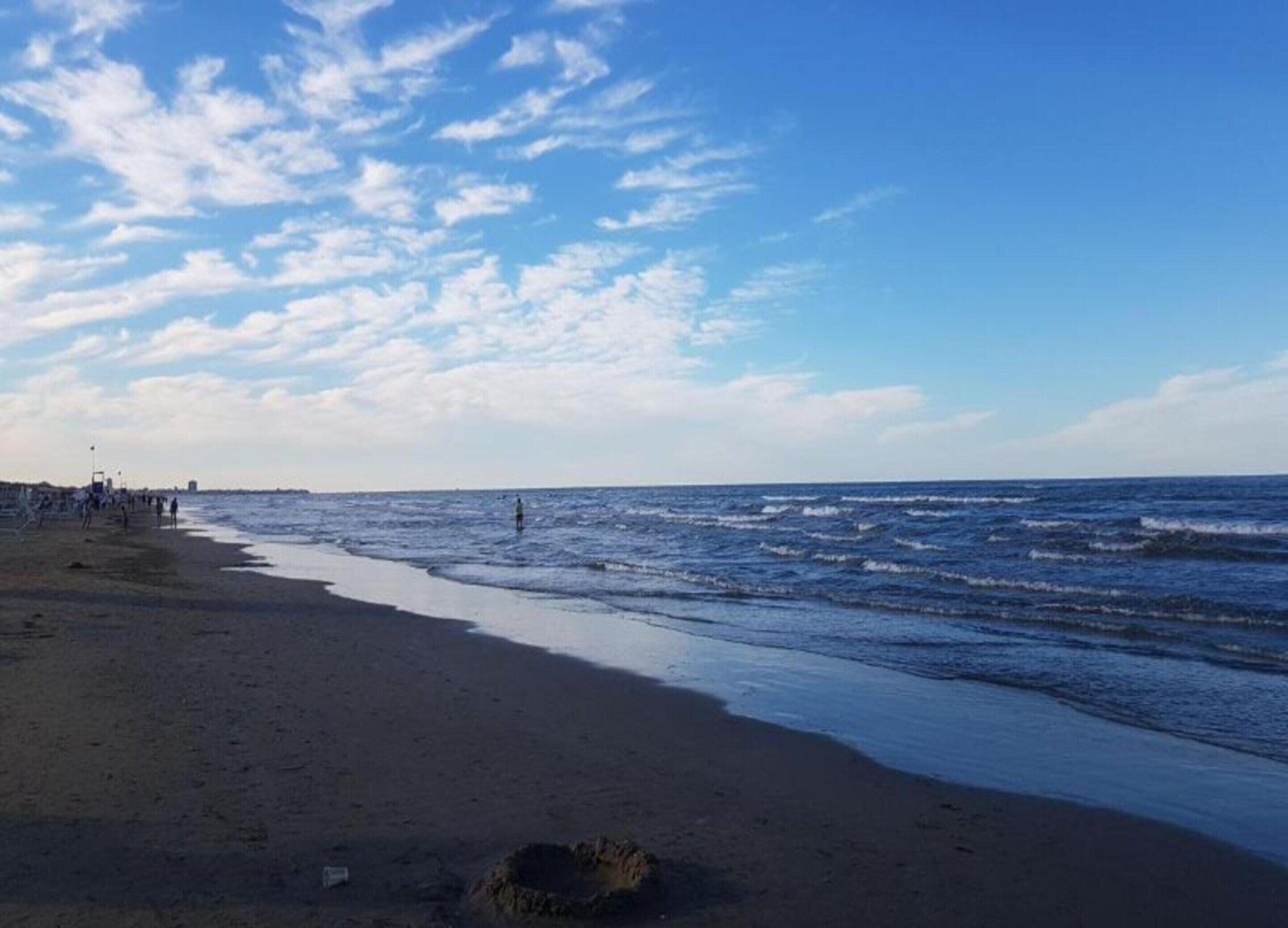 A beach with a sandy shore and waves.