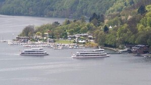 A marina with several boats docked, surrounded by a forested hillside. - Luxurious Apartment in Waldeck With Sauna (Waldeck)