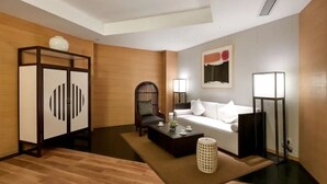 A modern living room with a sofa, coffee table, and decorative items.