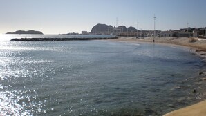 A coastal scene with a clear sky, calm sea, and a sandy beach. - DUPLEX APARTMENT, SEA VIEW (La Cadière-d'Azur)