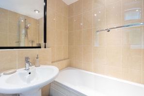 Combined shower/bathtub, hair dryer, towels, soap