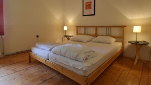 A single bed with a wooden frame, two bedside tables, and a wall-mounted picture. - Lavish Holiday Home in Abertamy near Ski Area (Abertamy)