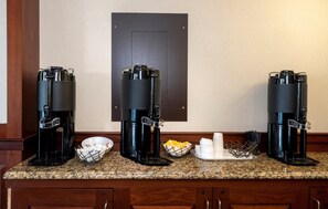 Three coffee makers on a kitchen counter with a door in the background. - HomeTowne Studios by Red Roof Wilmington - New Castle (New Castle)