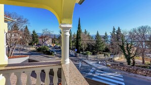 A balcony with a view of a street and surrounding trees. - Charming Home With Swimming Pool and Beautiful Covered Terrace (Crikvenica)
