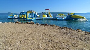 An inflatable water park with various play structures and slides. - Country House in Croatia With Pool (Crikvenica)