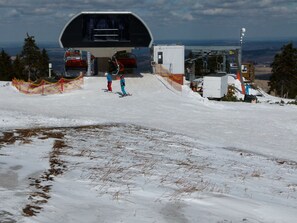 A ski lift station with a covered waiting area and a view of the snowy landscape. - Holiday Home in Pernink in a Beautiful Mountainous (Pernink)