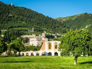 A historic town with medieval architecture, including a prominent castle and a church with a bell tower. - Secluded Mansion in Perugia with Hot Tub (Perugia)