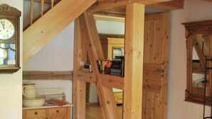 A wooden staircase with a wooden ceiling and a clock on the wall. - Watermill Stay With Garden (Heringen)