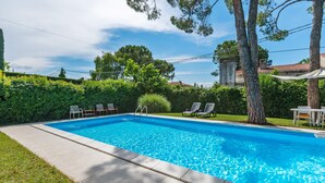 A rectangular swimming pool with clear blue water, surrounded by a paved deck. - Spacious Lake Garda Villa With Private Pool, Garden and Direct Lake Access (Lazise)