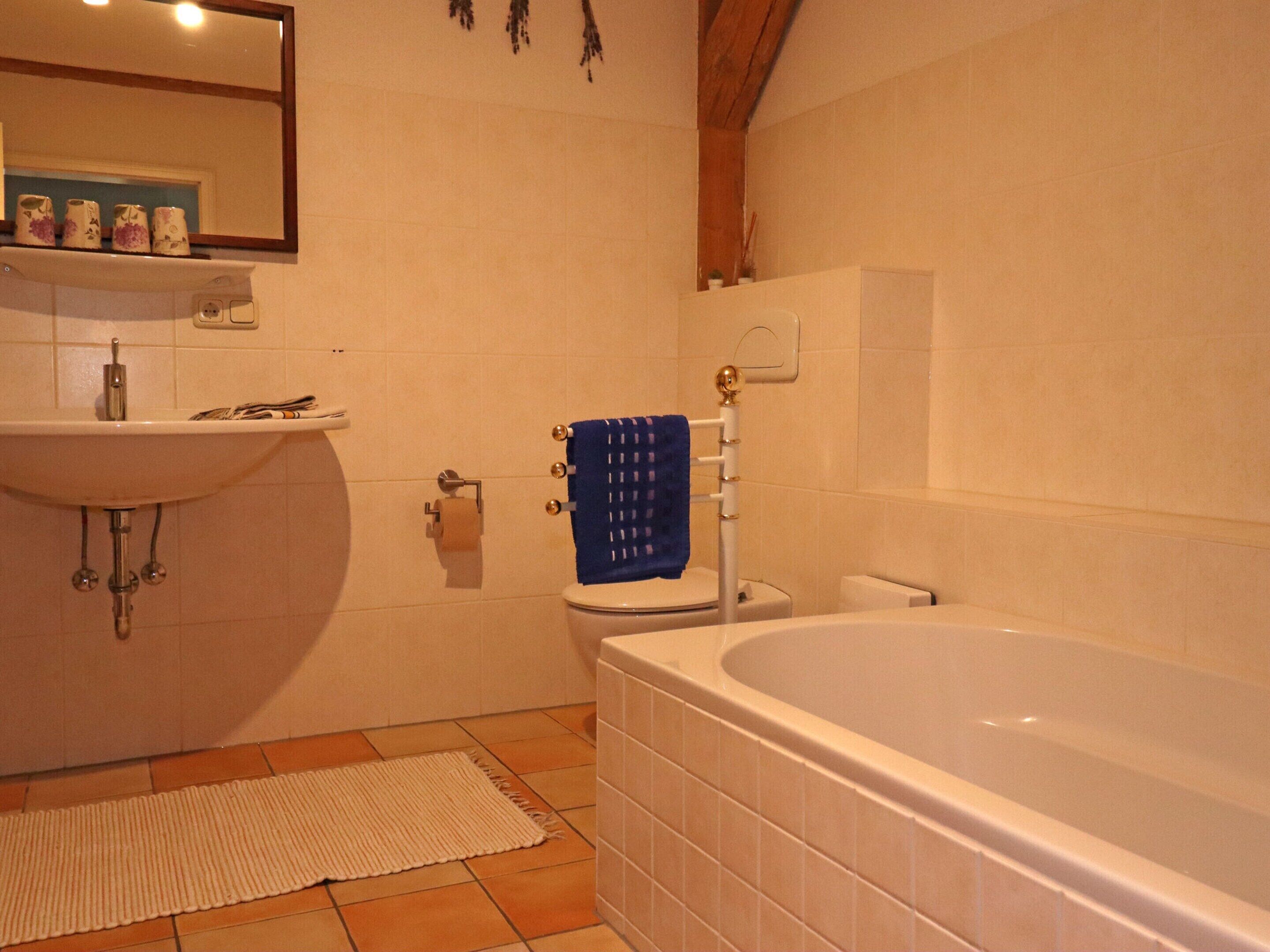 A bathroom with a sink, toilet, and bathtub.