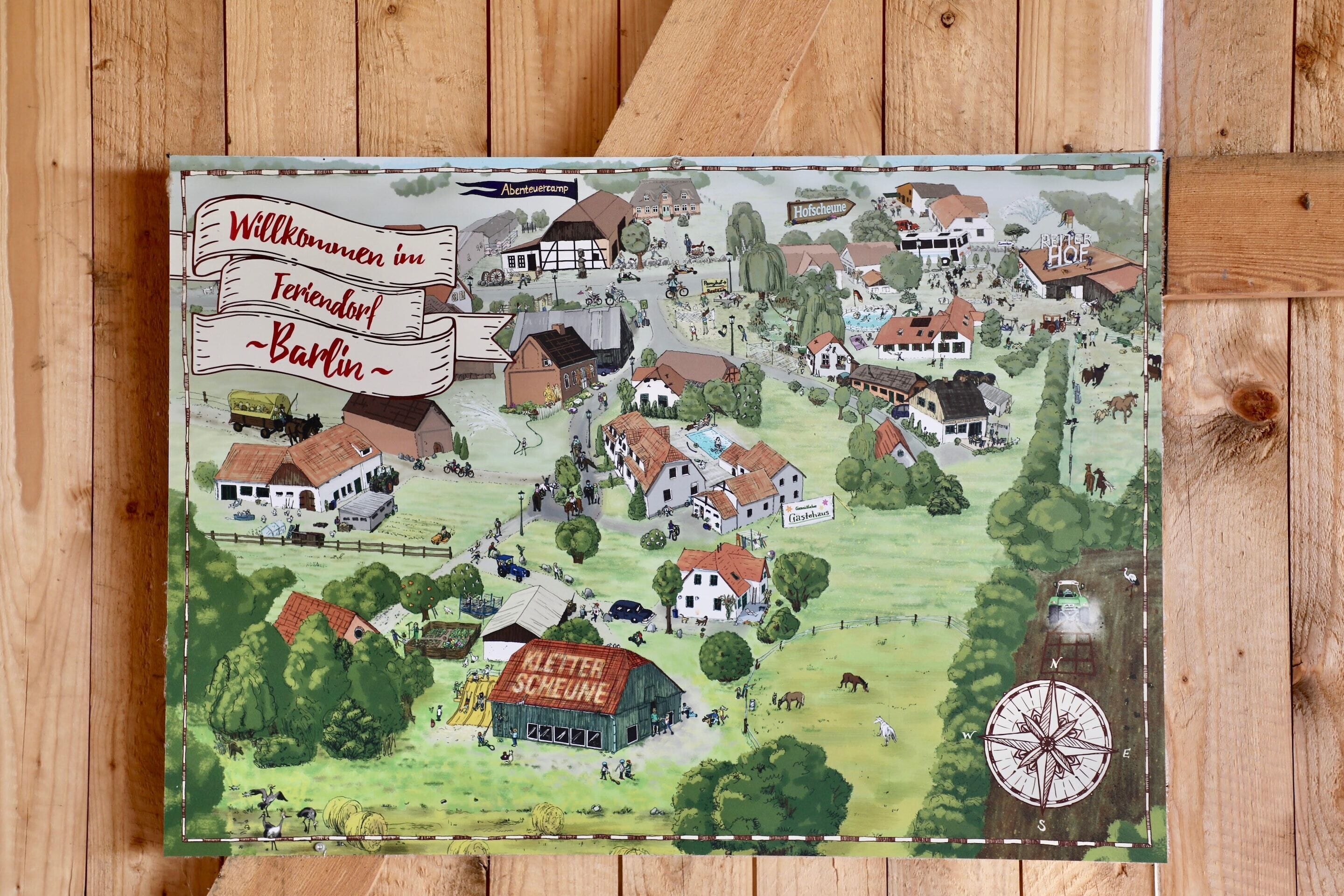 A detailed map of a village with various buildings, including houses, a barn, and a swimming pool.