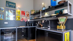 A modern kitchen with a built-in oven, a coffee maker, and various kitchen utensils. - Steffenshagen Vicarage Retreat (Steffenshagen)