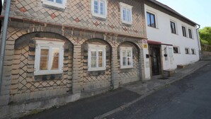 A two-story building with a stone facade and multiple windows. - Relaxation Holiday Home (Jiretin pod Jedlovou)
